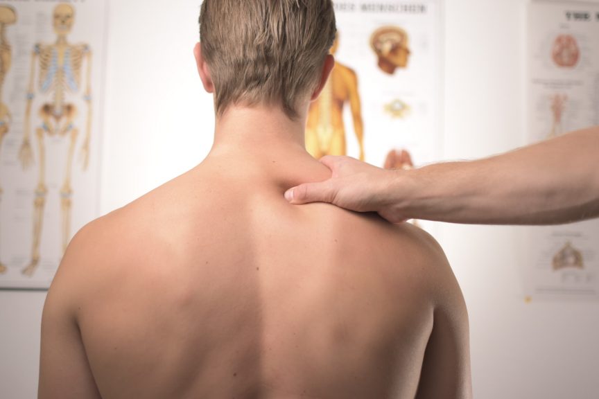 A man having a soft tissue massage to his neck and shoulders